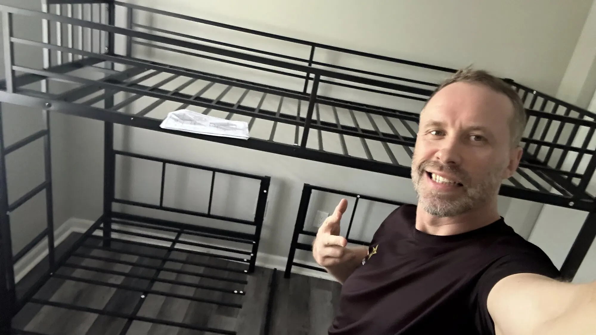 Alex of Handy Daddy giving a thumbs up beside a fully assembled metal bunk bed
