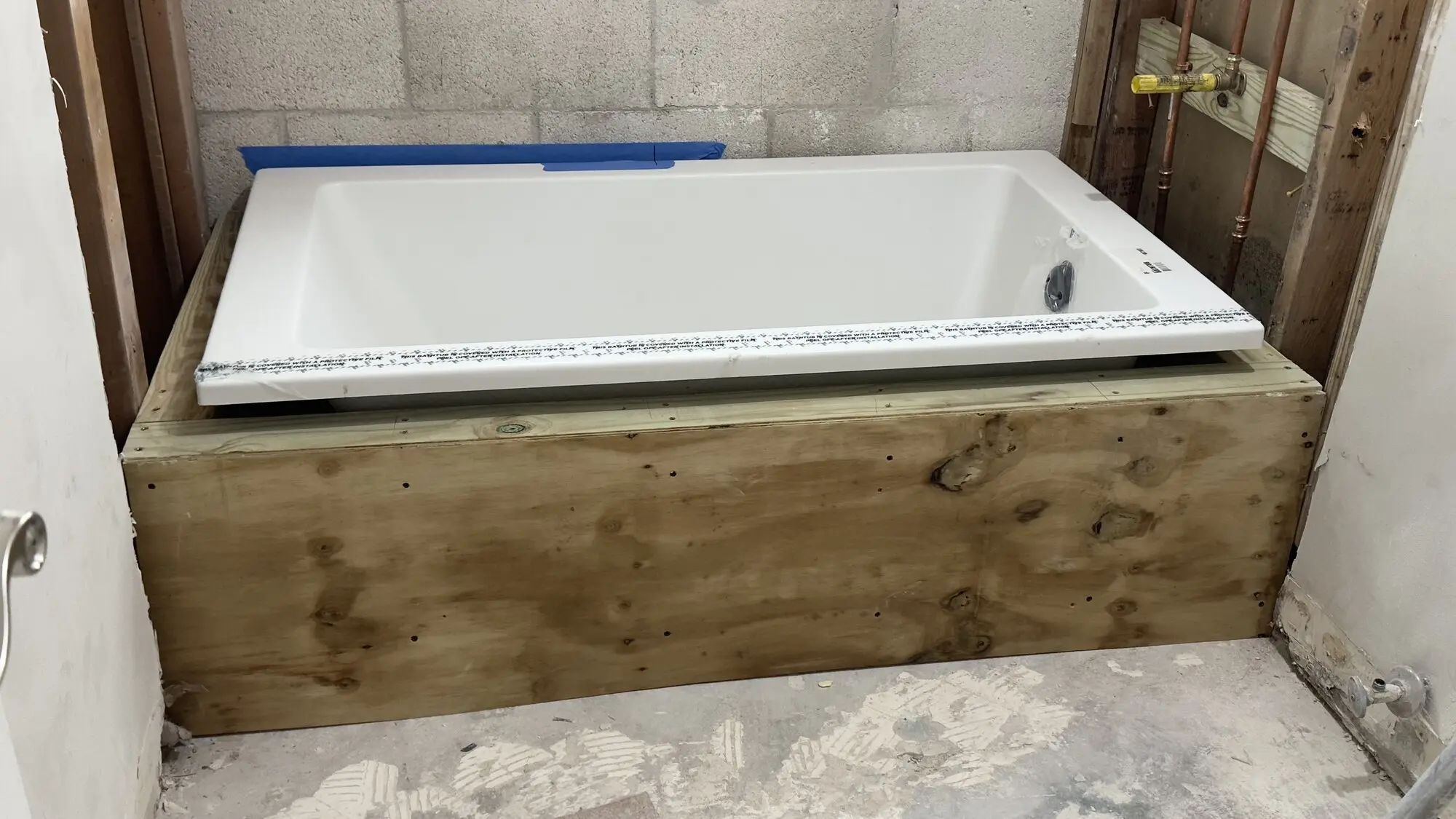 Bathtub surround fully framed and sheathed in plywood ready for finishing