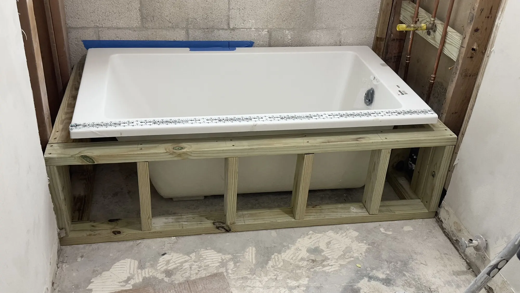 New bathtub set in place with timber framing being built around it