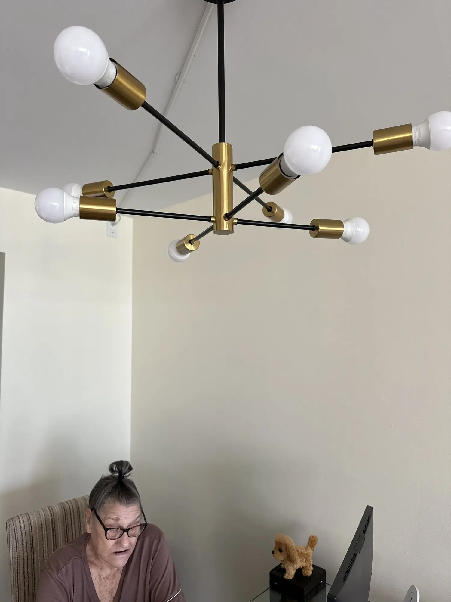Black and brass sputnik chandelier installed on a white ceiling