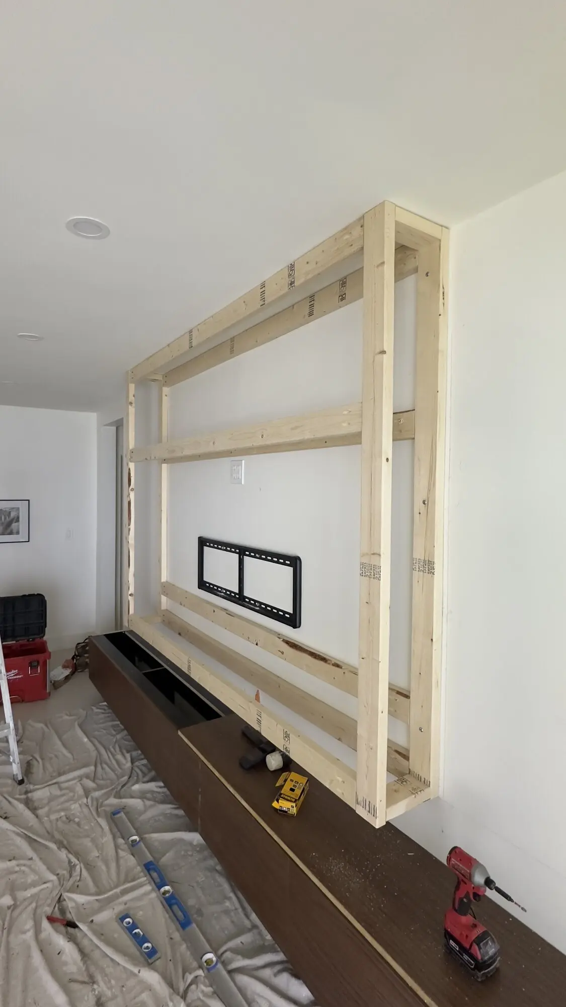 Timber framing for a built-in media wall unit under construction