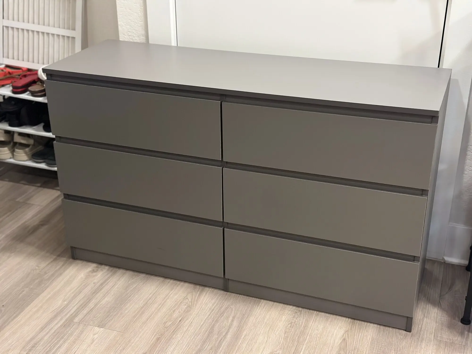 Charcoal gray six-drawer dresser assembled in a bedroom