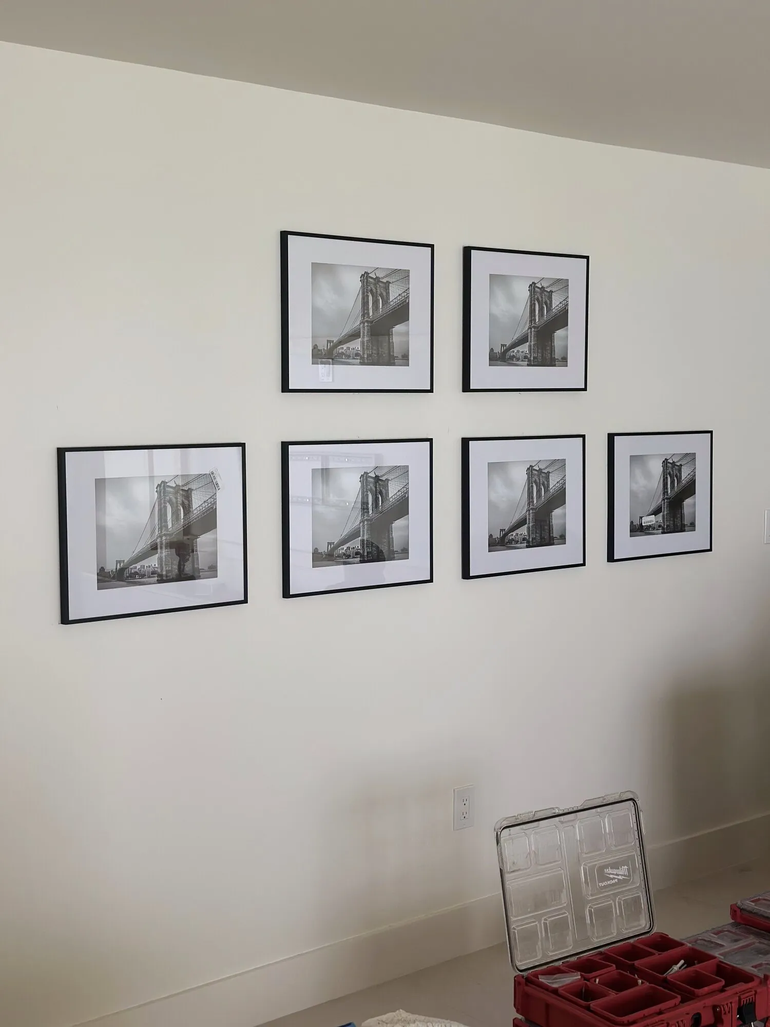 Six matching frames hung in an aligned grid gallery wall with even spacing