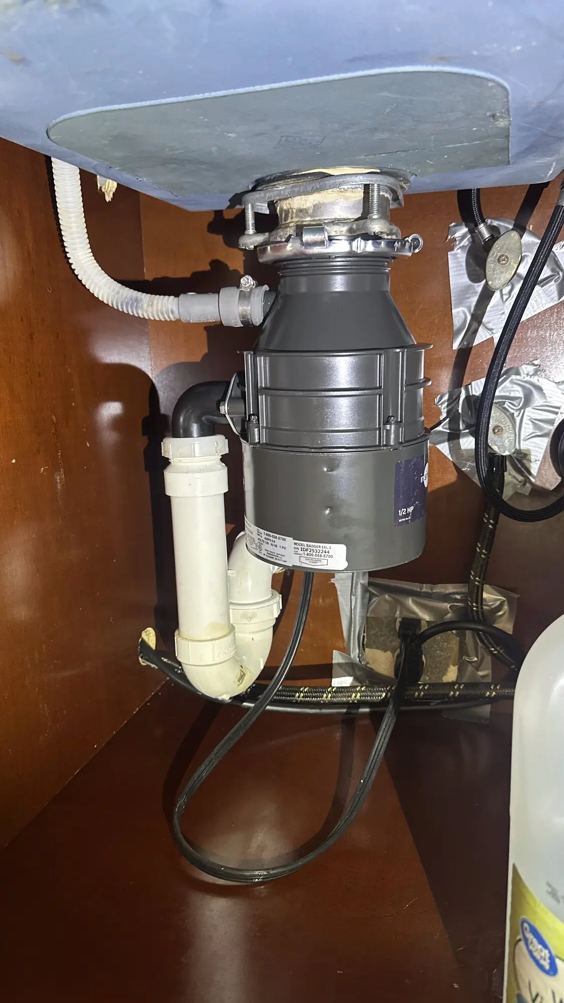 Garbage disposal replacement under a kitchen sink cabinet