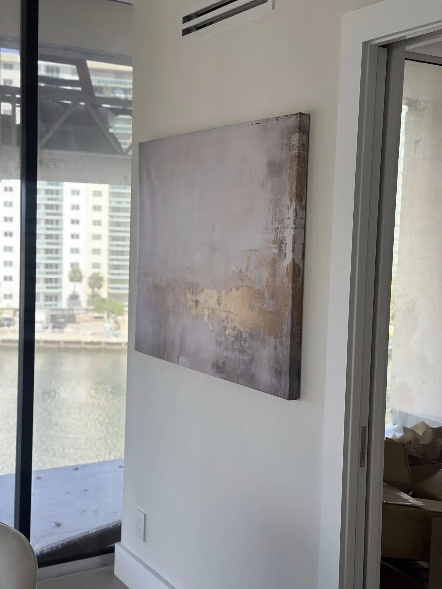 Large abstract canvas hung on a wall in a waterfront condo with an Intracoastal view