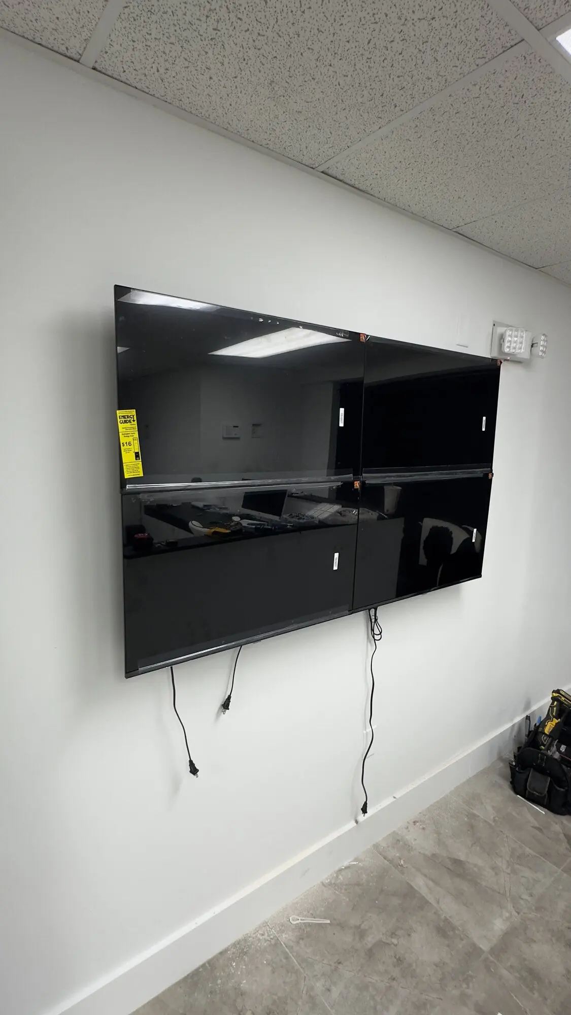 Large flat-screen display mounted on a wall in a commercial office space
