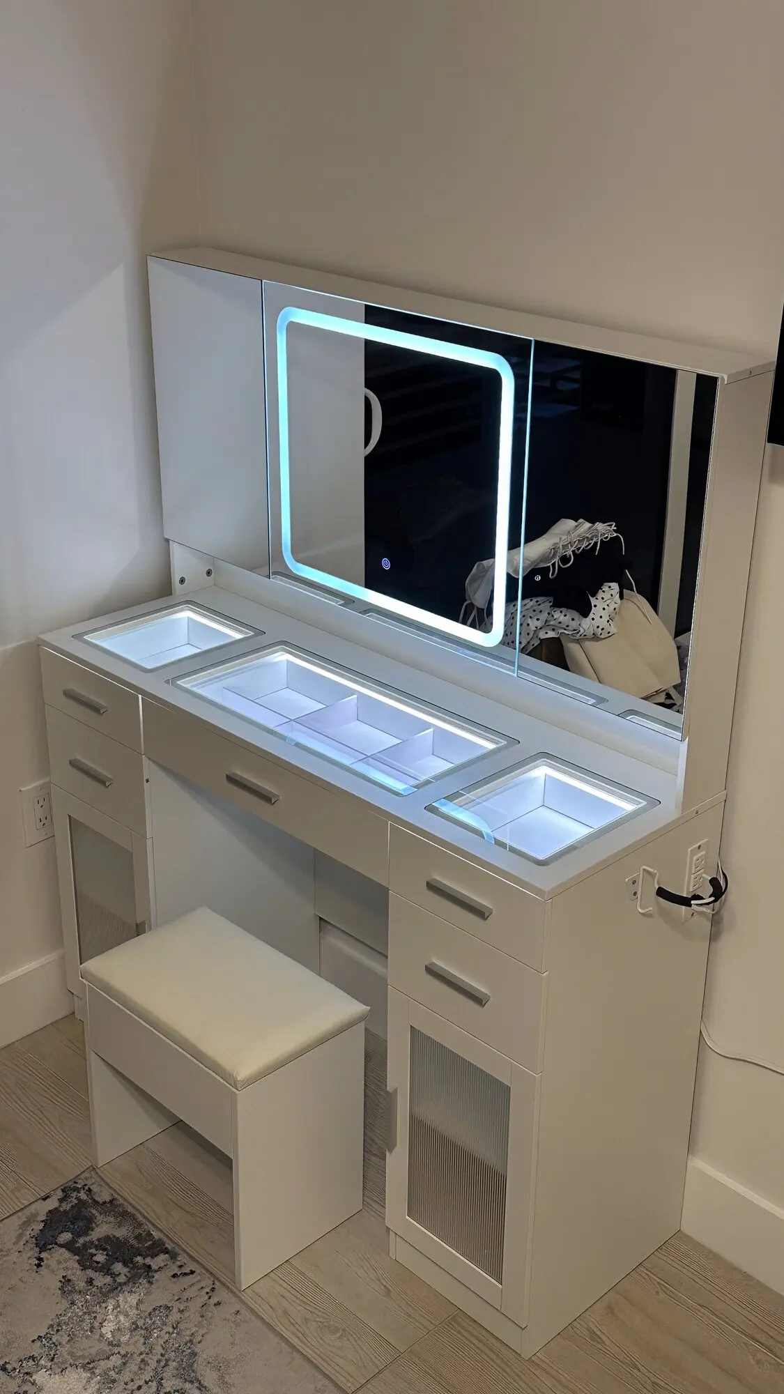 LED-lit makeup vanity desk with mirror assembled in a bedroom