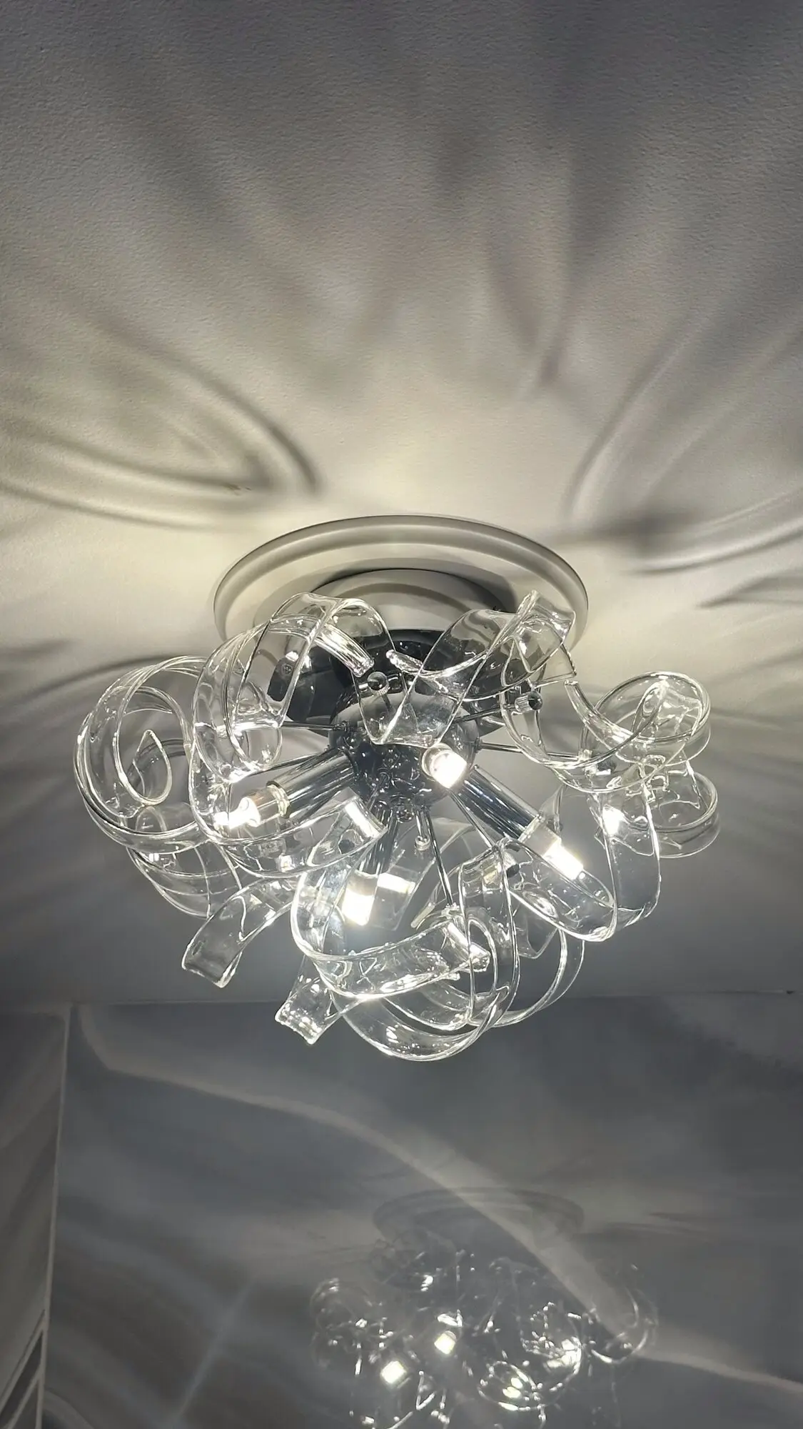 Modern chrome and glass flush-mount ceiling light installed
