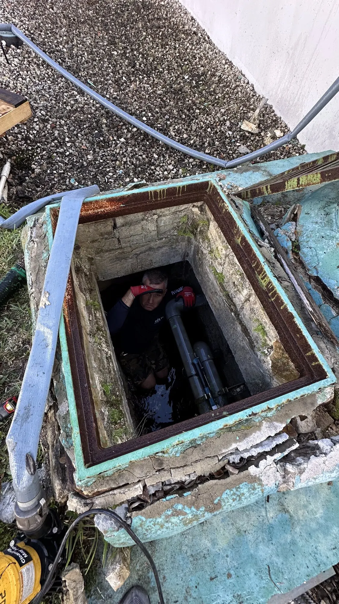 Outdoor utility pit opened for equipment repair work