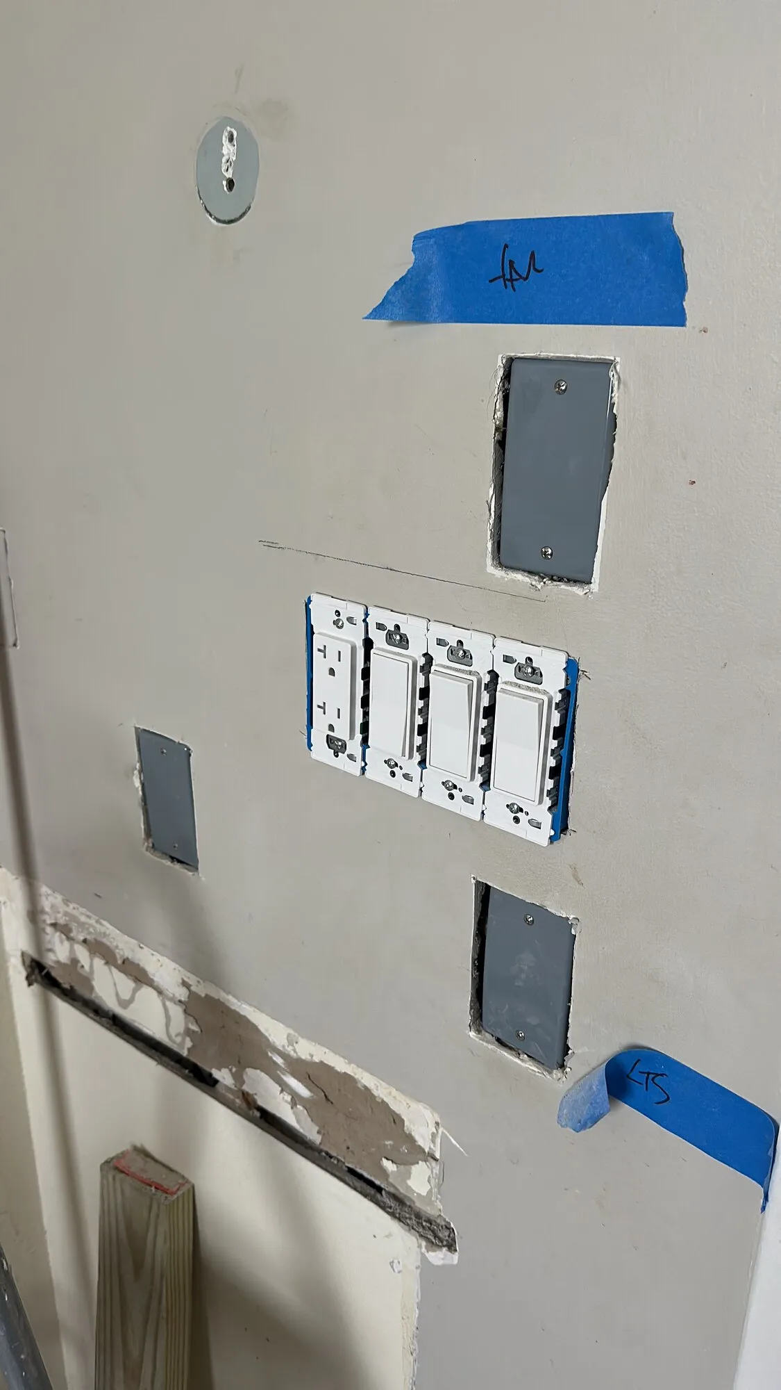 Wall with switch and outlet boxes prepared for device installation