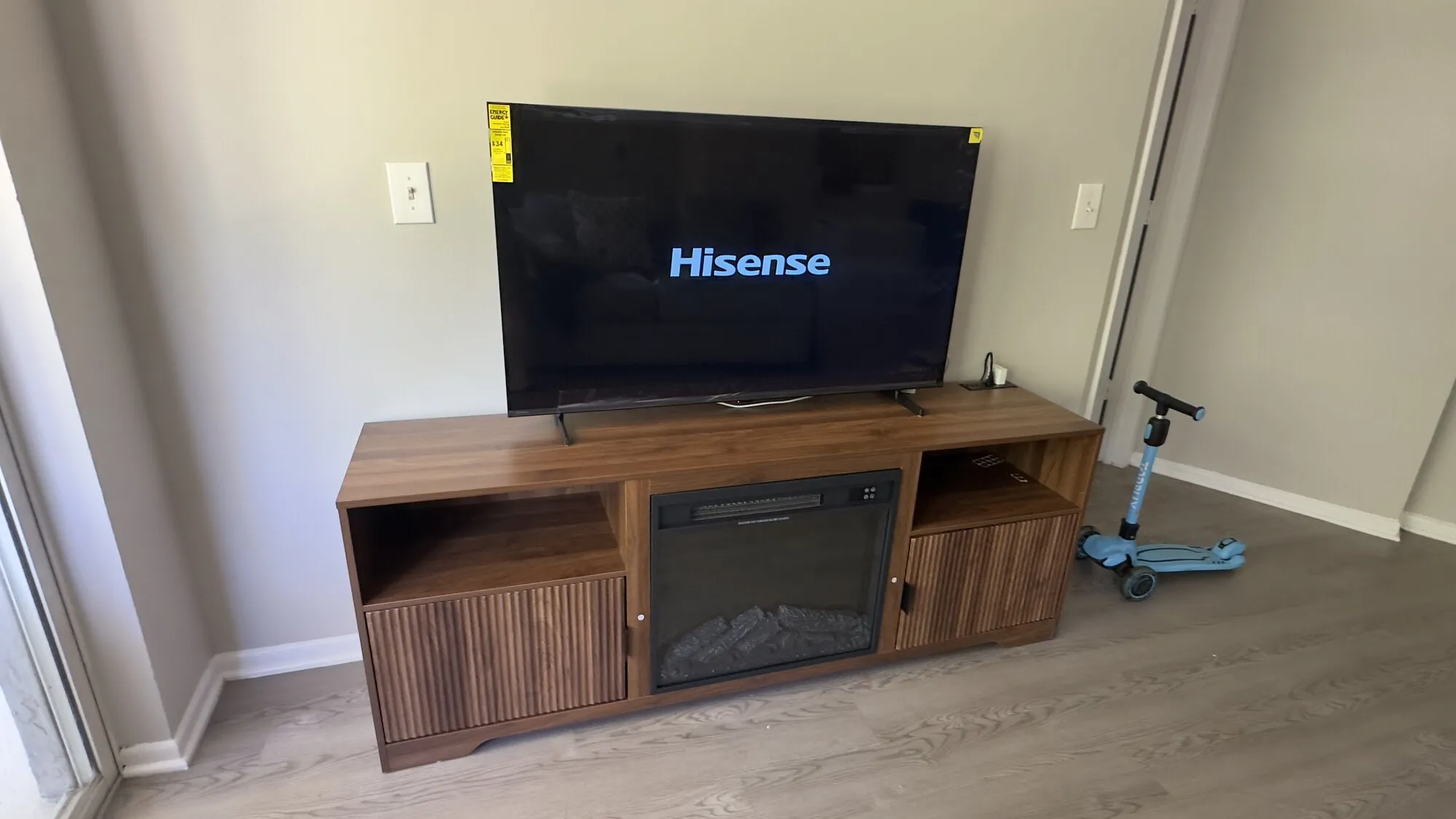 Wall-mounted TV positioned above a low media console in a living room