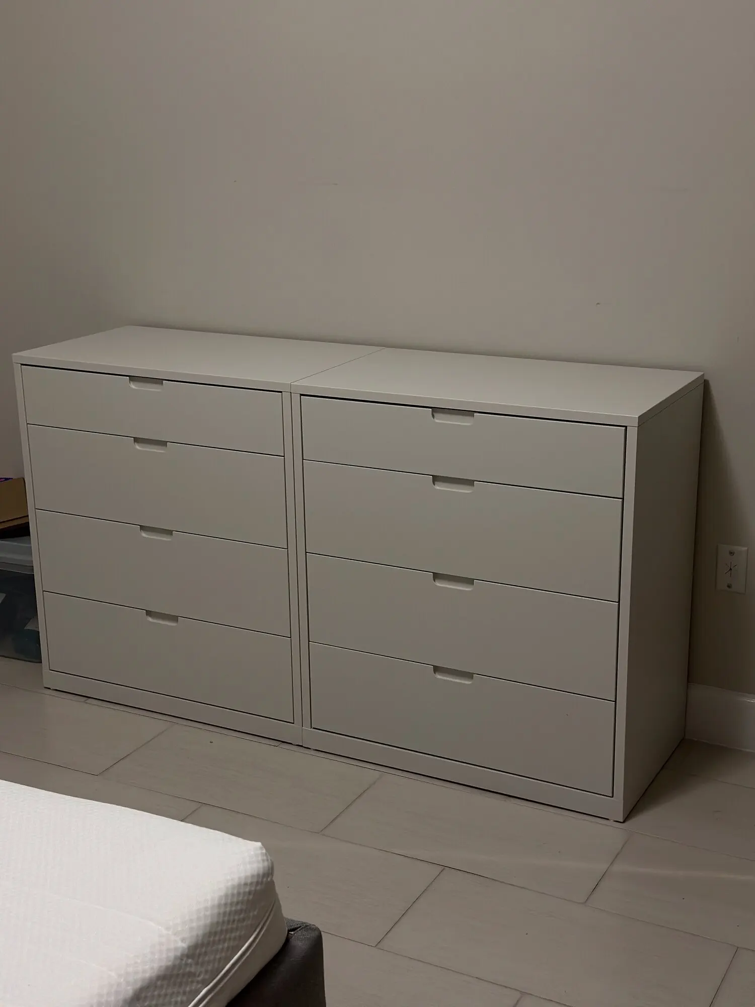 White eight-drawer dresser assembled in a bedroom