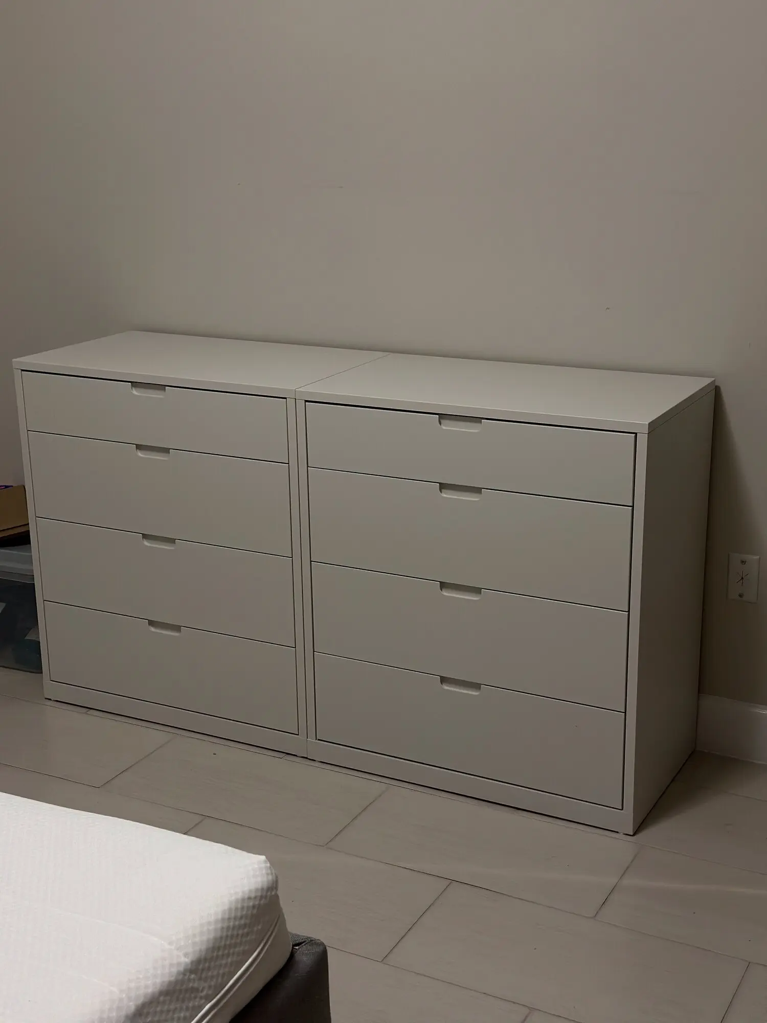 White eight-drawer dresser assembled in a bedroom